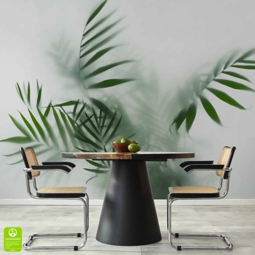 Nowoczesna jadalnia z okrągłym stołem i designerskimi krzesłami. Tło stanowi minimalistyczna fototapeta z efektem głębi, ukazująca zielone liście palmowe za mgłą, co nadaje pomieszczeniu przestrzeni