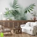 Salon w stylu rustykalnym z białą kanapą i drewnianą komodą. Na ścianie zastosowano fototapetę na wymiar przedstawiającą liście palmy we mgle, która tworzy we wnętrzu relaksującą i wyciszającą atmosferę