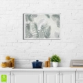 plakat-srebrna-ramka-wnetrze-egzotyczne- liscie-palmy-i-monstery-do-sypialni-salonu.webp